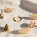 Personalised gold name ring on white linen background